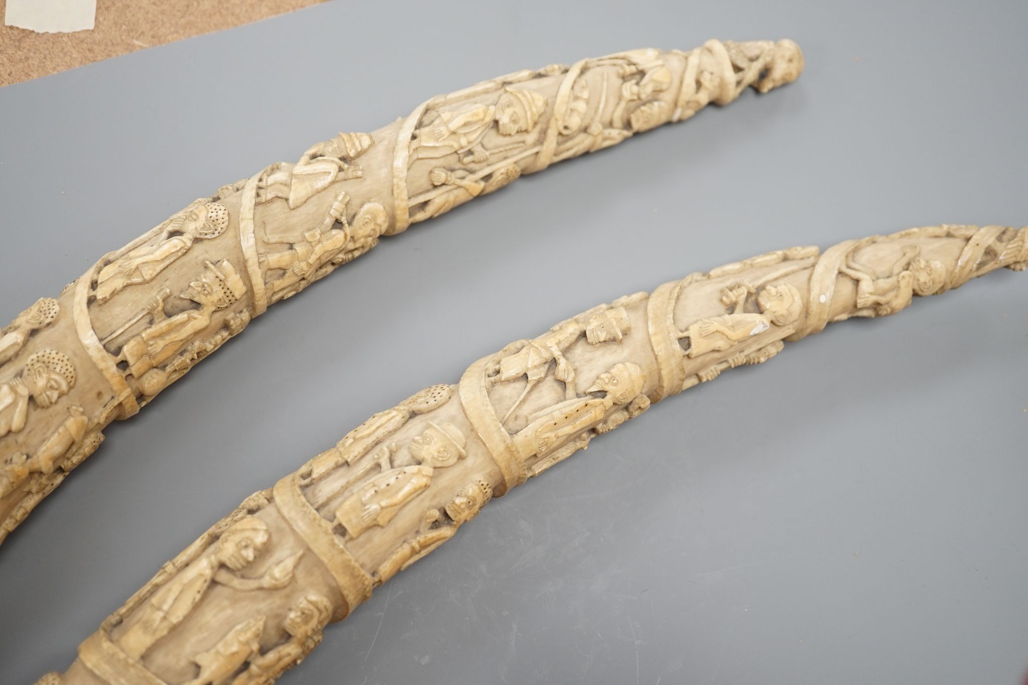 Two Loango carved ivory tusks, Republic of Congo, mid to late 19th century, 46cms long.